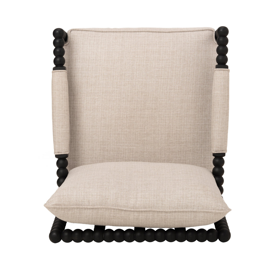 Top view of cream fabric accent chair with padded arms and black beaded wood frame