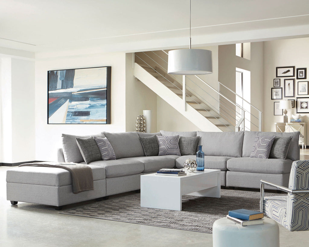 Grey modular sectional sofa with corner chaise, upholstered in light fabric