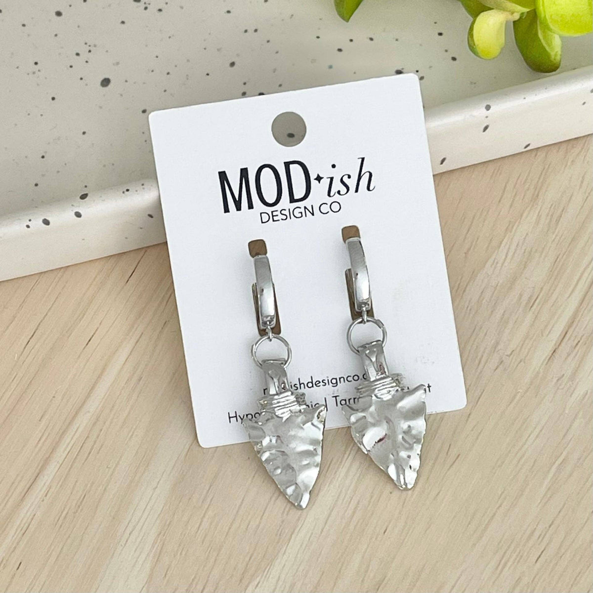 Silver-tone arrowhead huggie earrings with clear stone accents