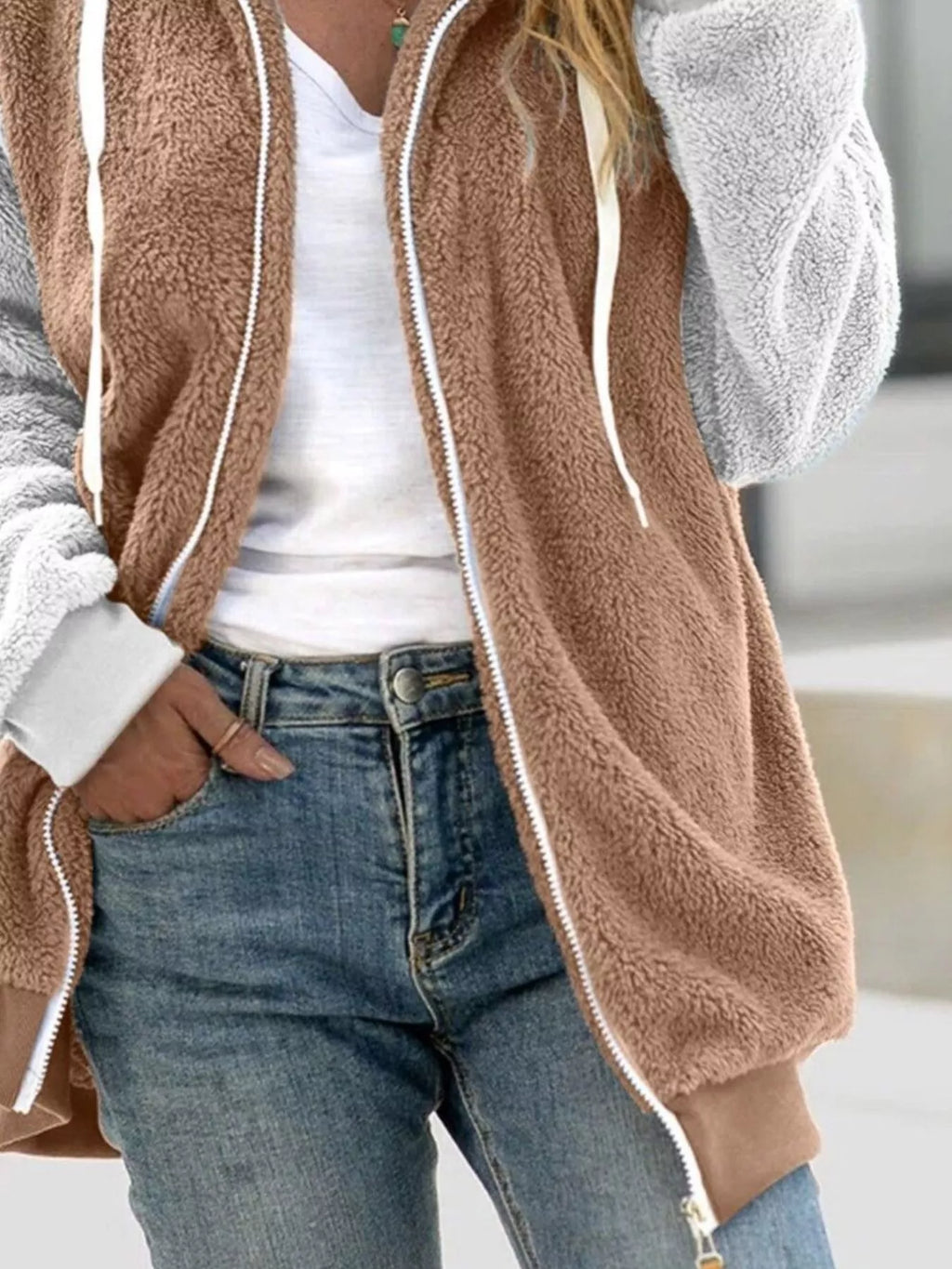 Tan fleece zip-up hoodie with drawstring hood and white zipper trim, light gray cuffs
