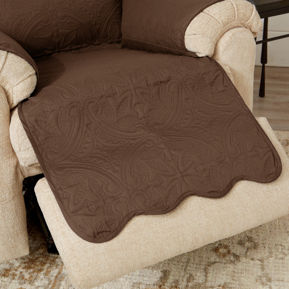 Brown recliner protector detail with quilted medallion pattern and scalloped edge