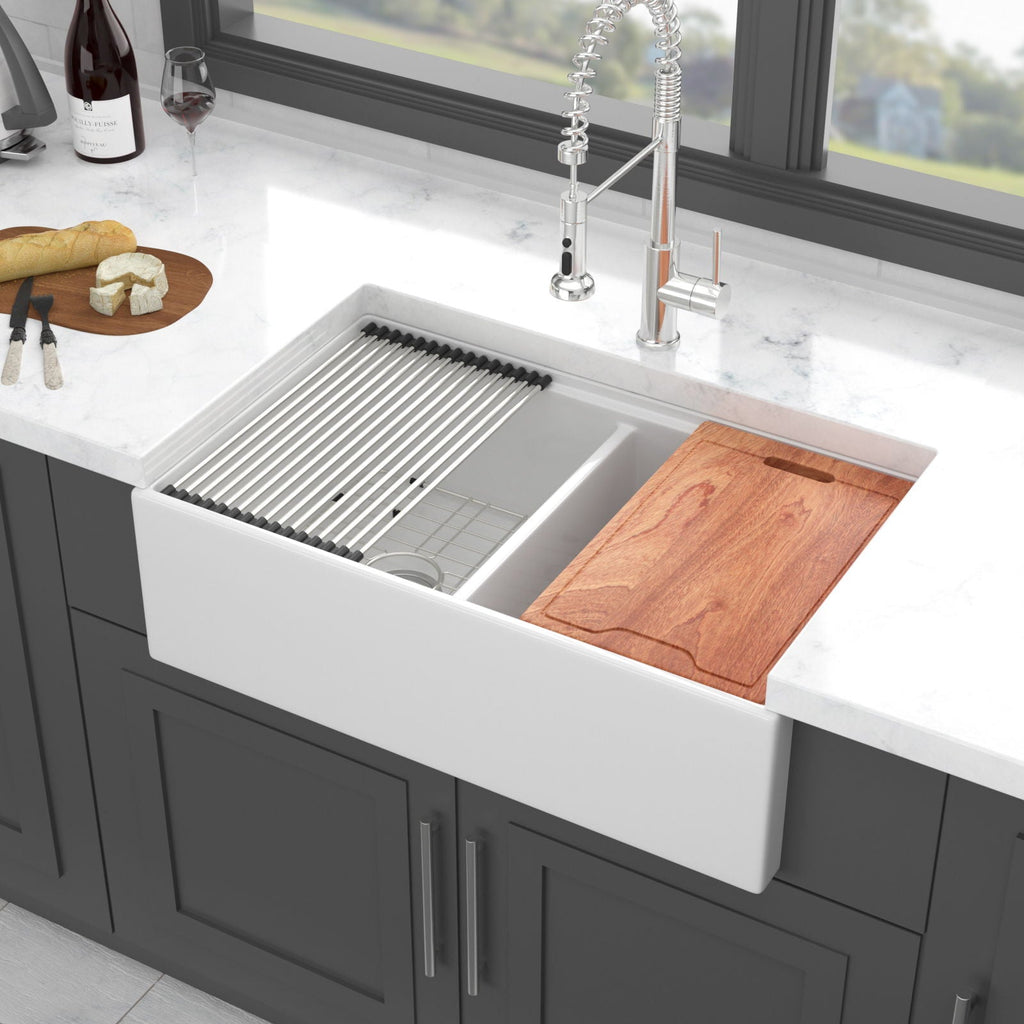 White ceramic double-bowl sink with ribbed ledge, rack insert, and wooden cutting board