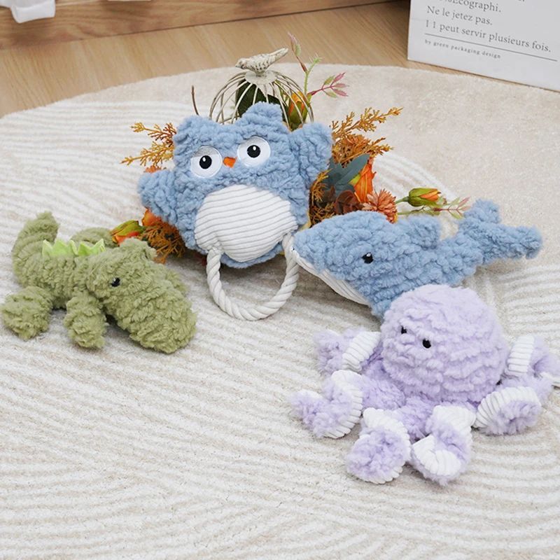 Assorted corduroy plush dog toys: blue owl, green crocodile, blue shark, purple owl