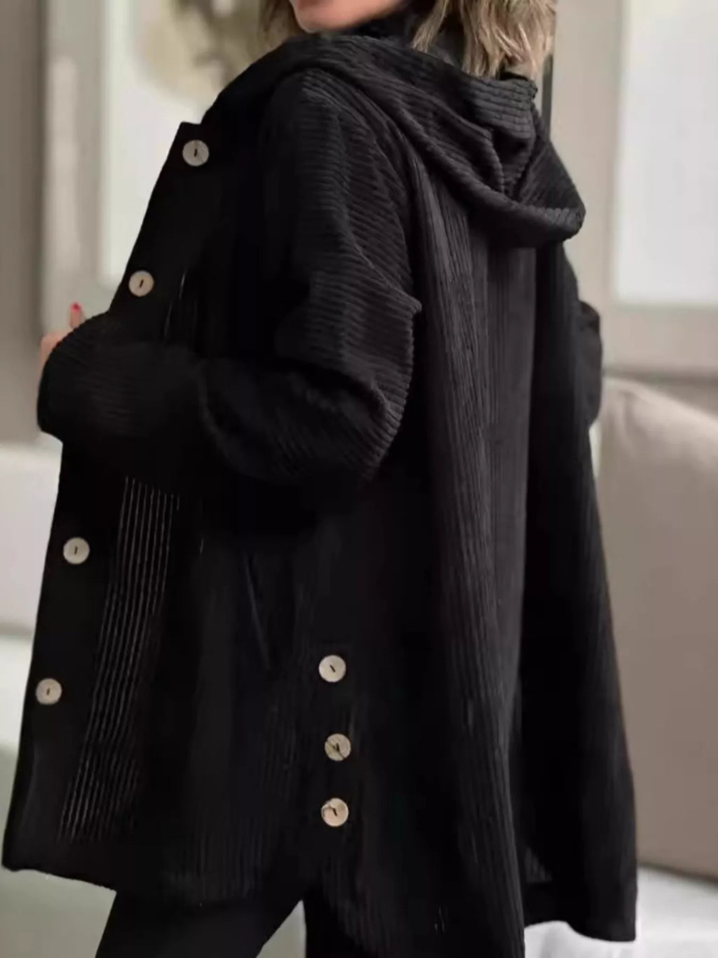 Black corduroy hooded jacket, side view, button front with roomy sleeves