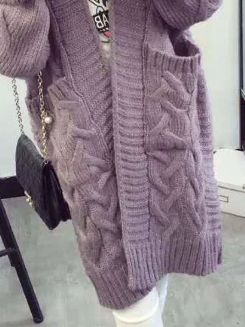 Lilac-purple knit cardigan front detail with braided cables and ribbed edges