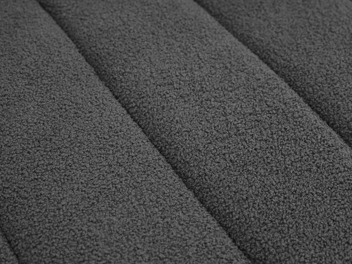 Dark gray lamb wool upholstery close-up with textured fabric