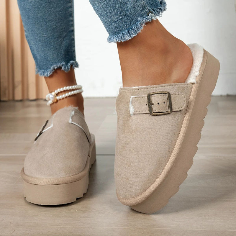 Plush-lined slip-on slippers in tan with faux-fur lining and buckle strap.