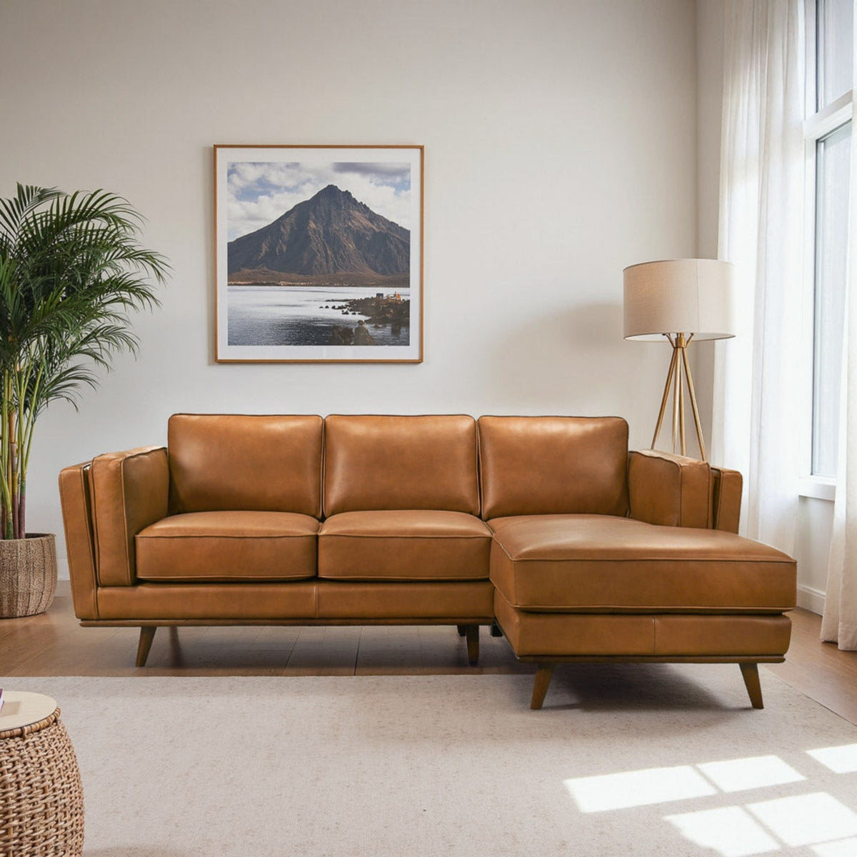 Light brown modular sectional sofa with rectangular arms and chaise extension on one end