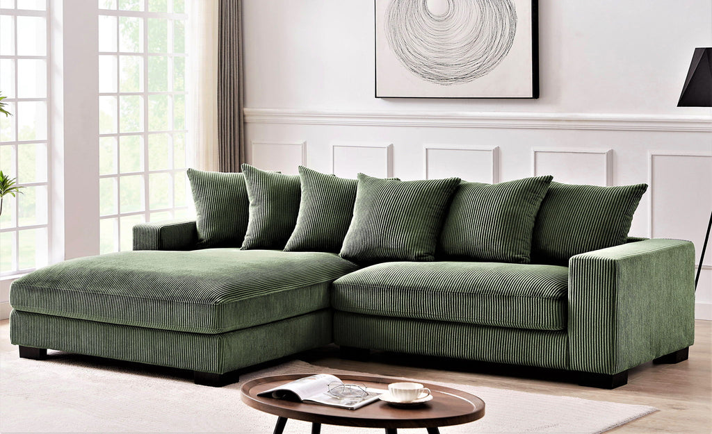 L-shaped sectional sofa with chaise, dark green, with tufted seat cushions and pillows