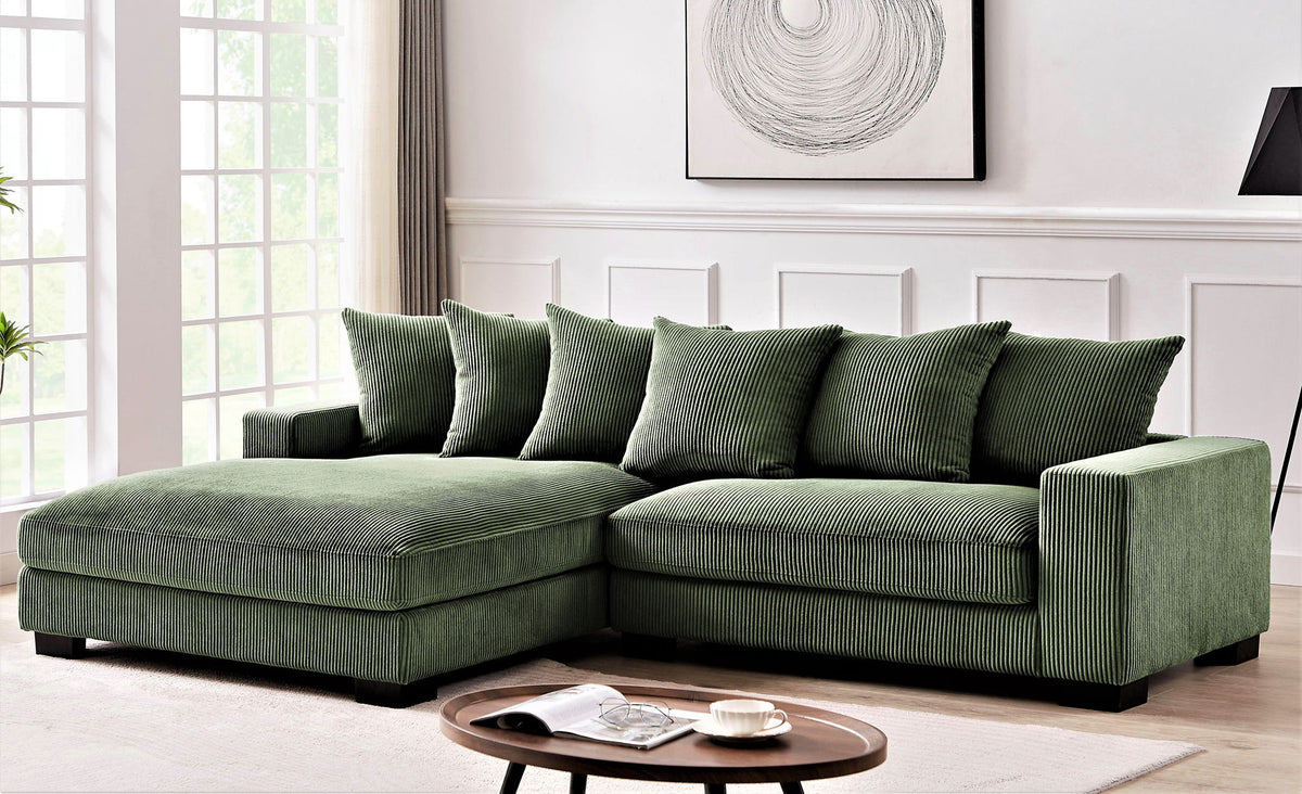 L-shaped sectional sofa with chaise, dark green, with tufted seat cushions and pillows
