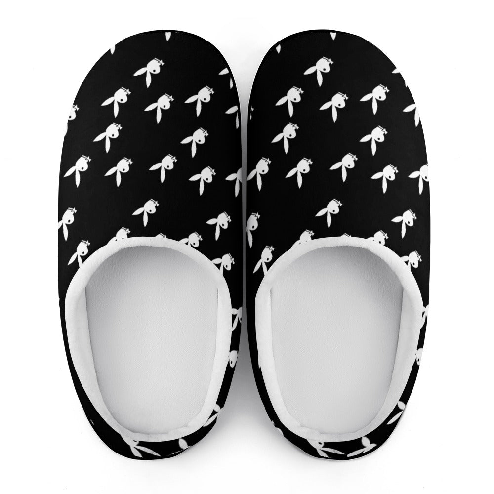 Pair of black slip-on slippers with white bow print and oval white inner lining