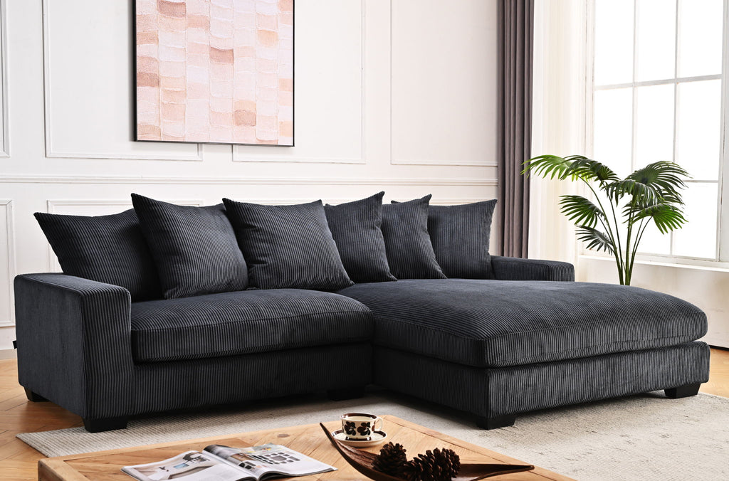 L-shaped sectional sofa with chaise in dark charcoal gray, chaise corner and back pillows