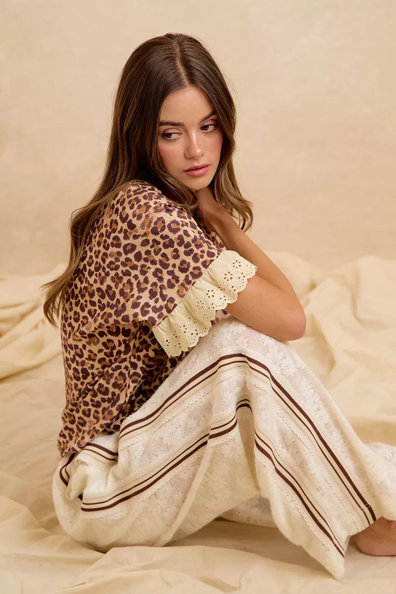 Leopard print ruffled top with eyelet lace shoulder trim, paired with striped shorts