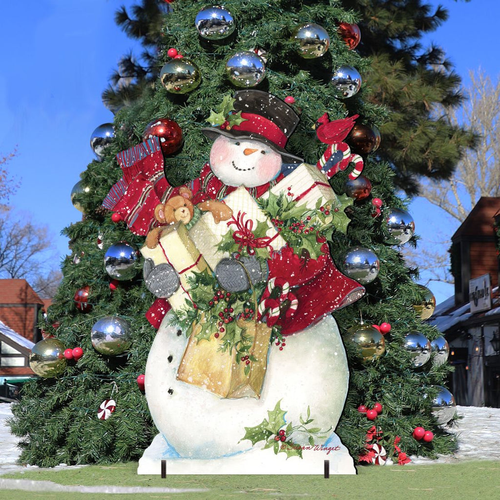 Christmas yard decoration sign of snowman peeking from a decorated outdoor tree display