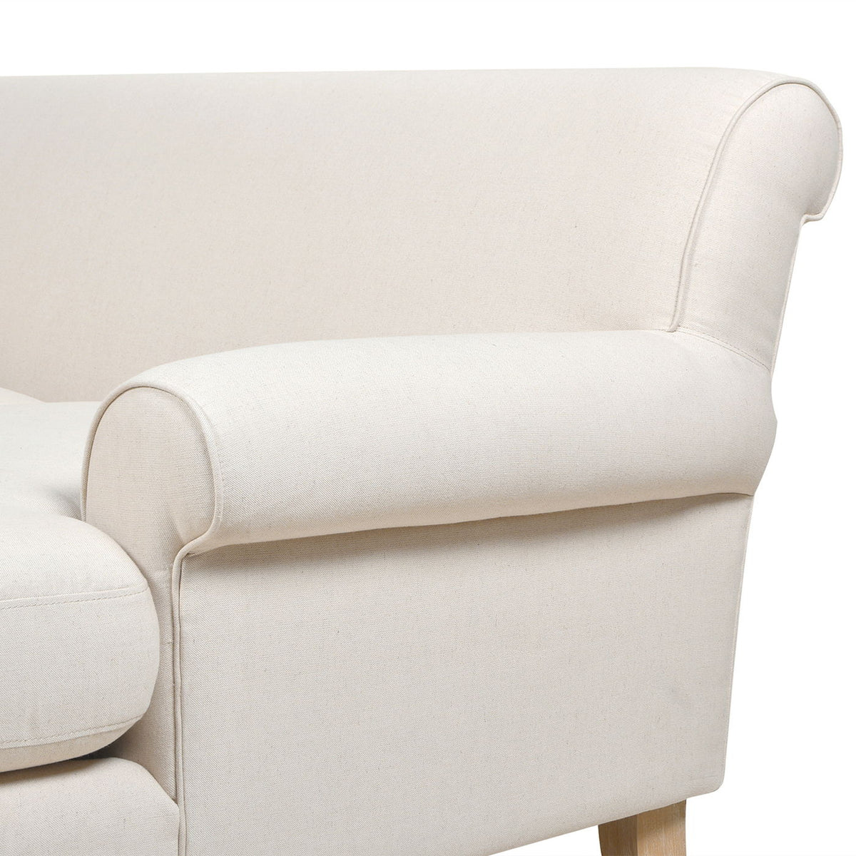 Light beige upholstered sofa arm with rounded armrest and neat stitched seams