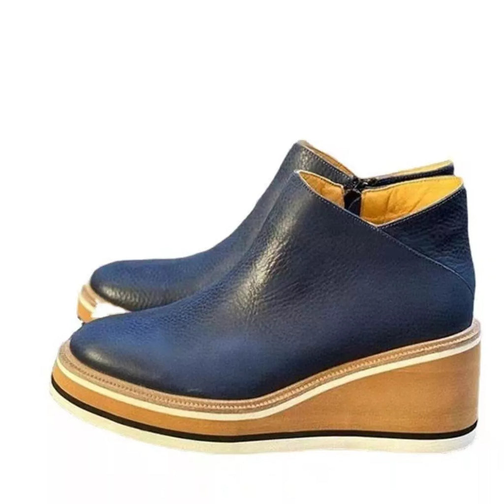 Navy ankle wedge boots with side zipper, cushioned collar, striped sole