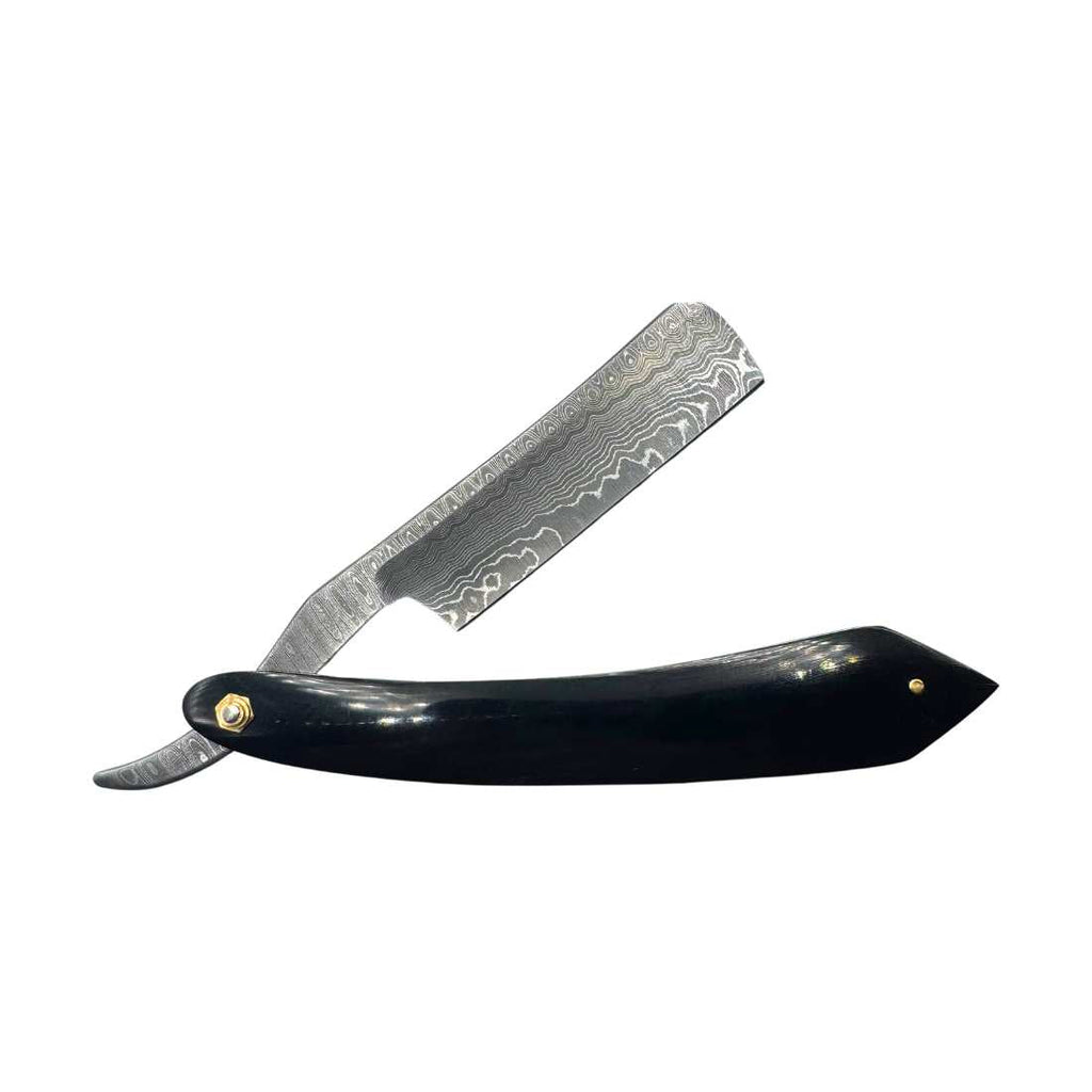 Straight razor with black handle and patterned steel blade