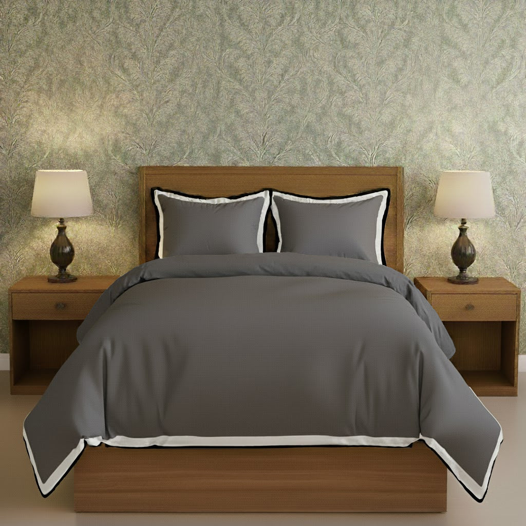 Dark gray duvet cover set with white border frame and matching pillow shams