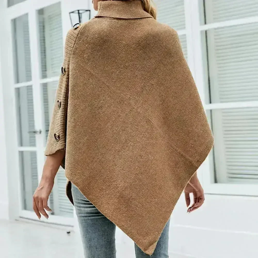 Back view of khaki turtleneck poncho with asymmetric hem and exposed button details, one size