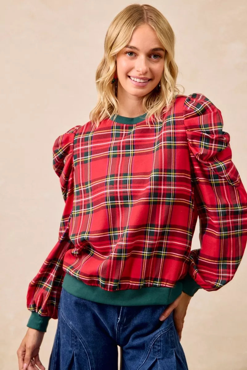 Red plaid long-sleeve top with bold puff shoulders and green crew neck trim