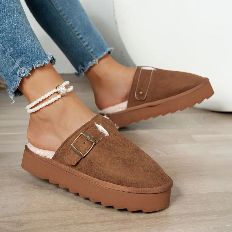 Plush-lined slip-on slippers in brown suede with faux-fur lining and buckle strap.