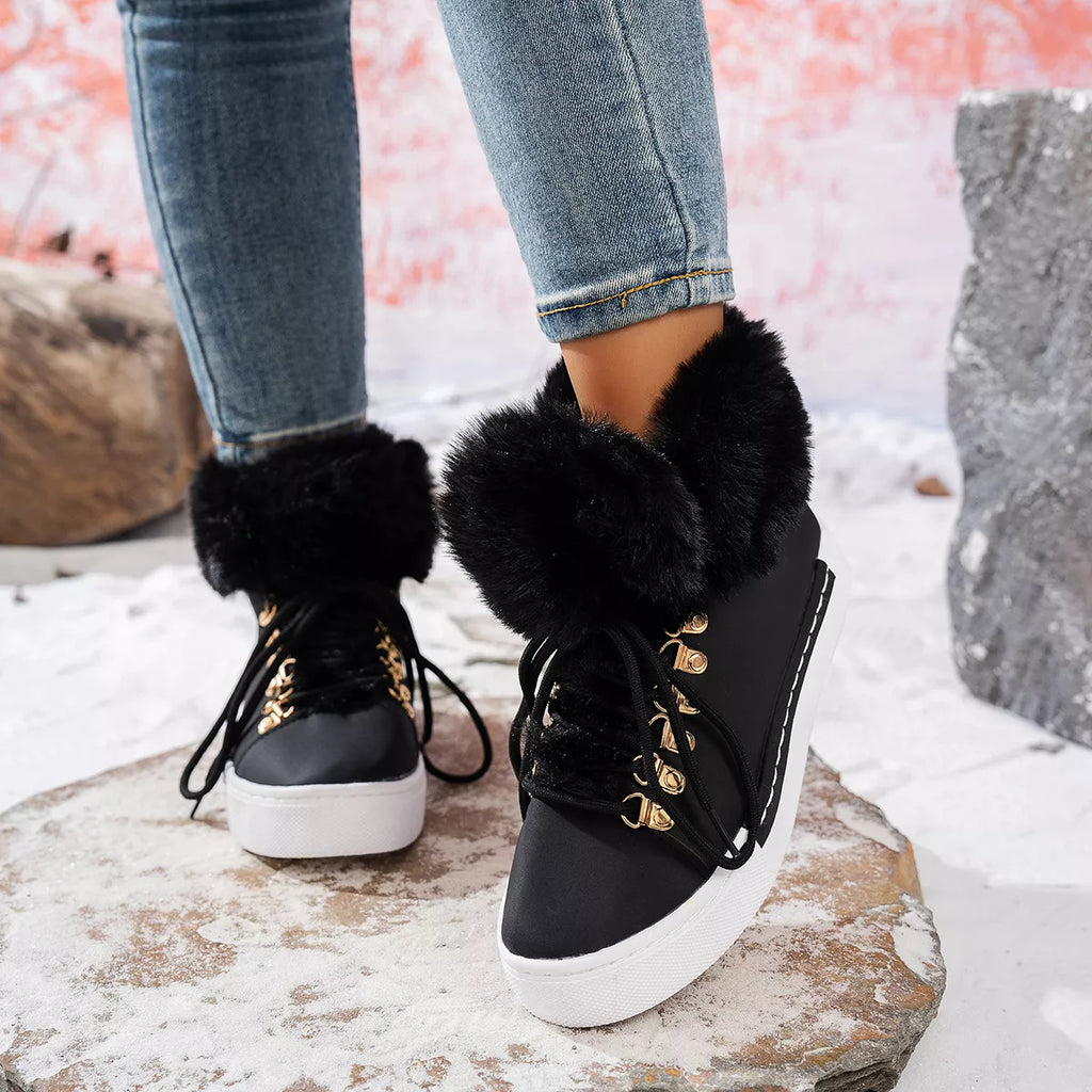 Black lace-up ankle boots with fluffy trim, gold eyelets, and white platform sole
