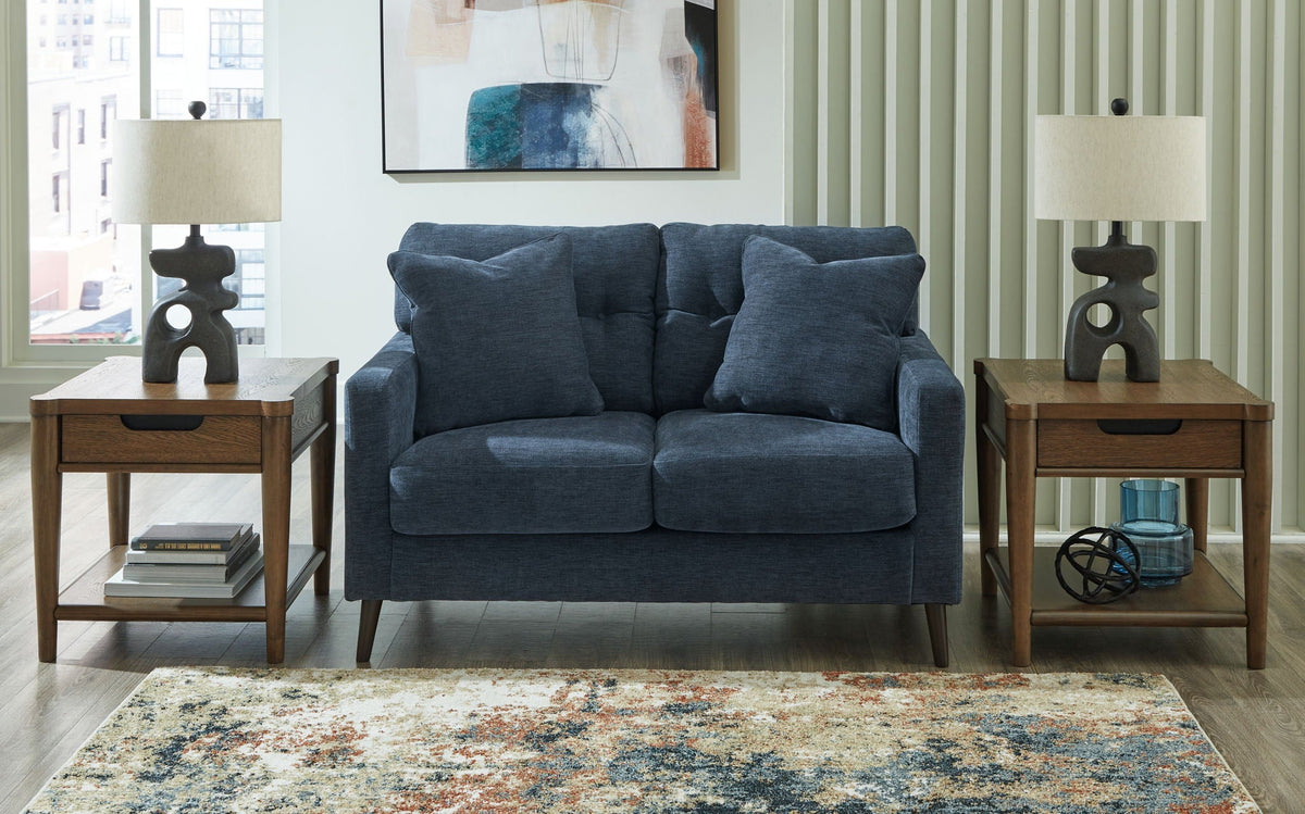 Blue upholstered 2-seat sofa styled in a living room setting