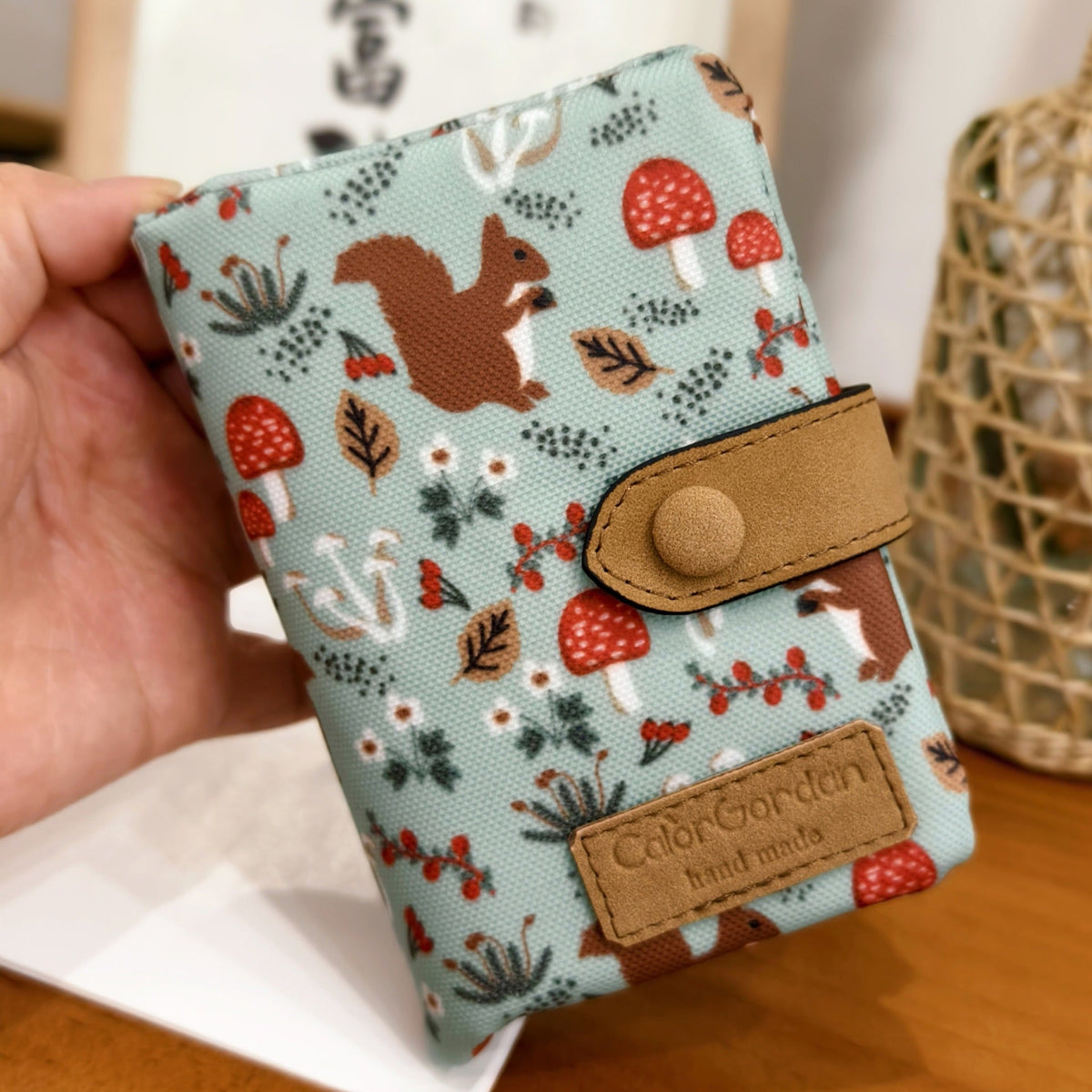 Printed tri-fold wallet with snap button, fox and strawberry pattern, tan leather patches