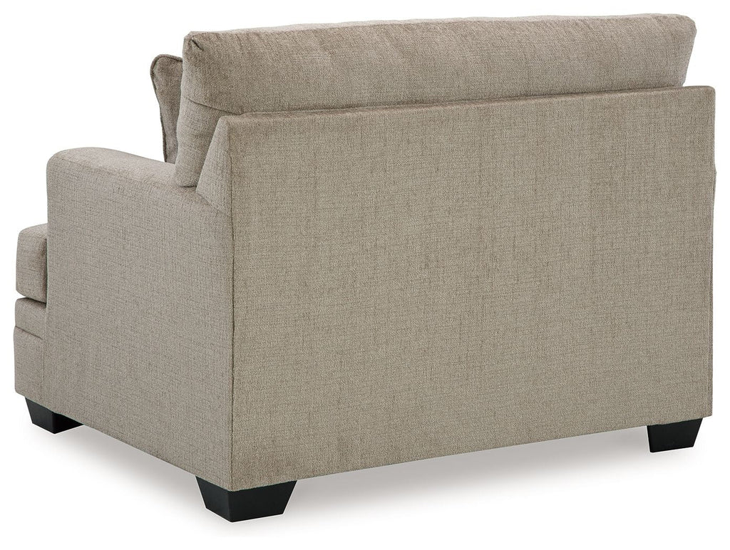 Light beige upholstered chair back and side panels with black block feet