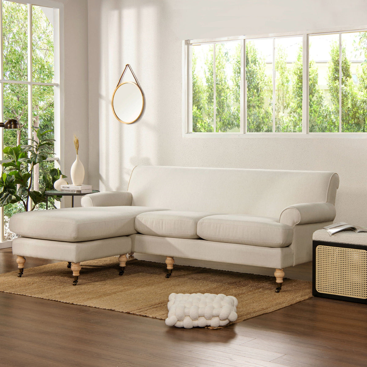 Light beige sectional sofa with chaise, wide cushions, and rounded backrest