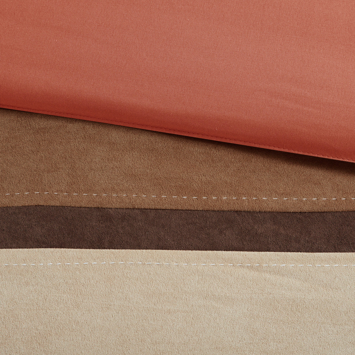 Faux suede fabric panel detail in coral and brown with cream accent stitching