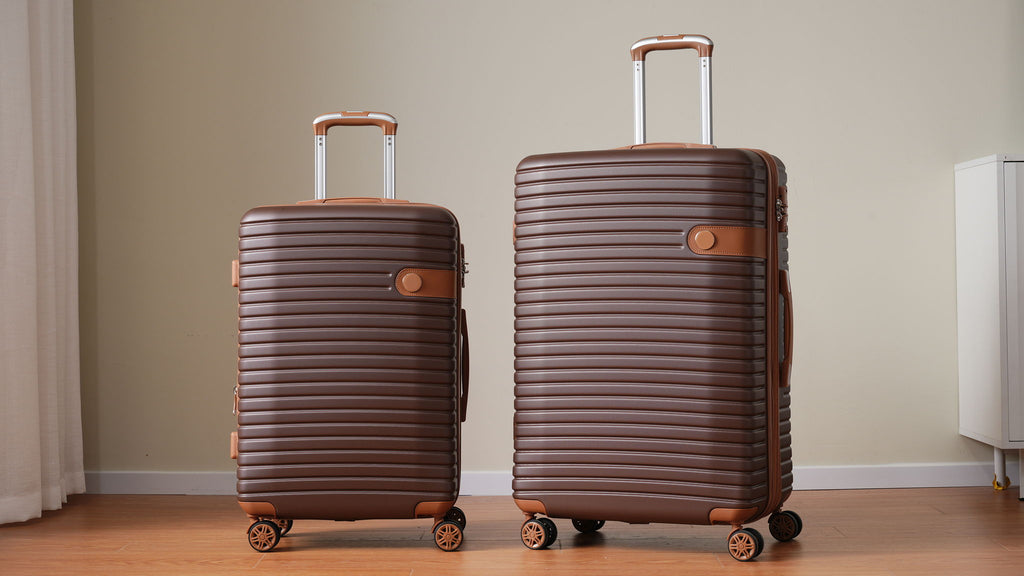 Two hard-shell suitcases in dark brown with telescoping handles and spinner wheels.