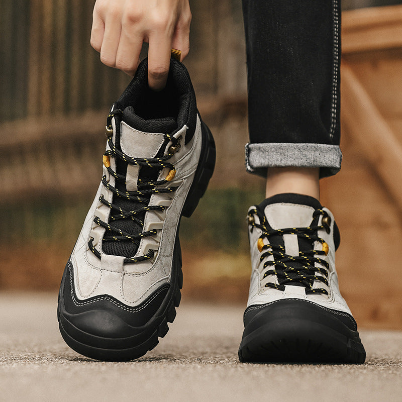 Pair of white and black high-top hiking boots with lace-up and padded collar
