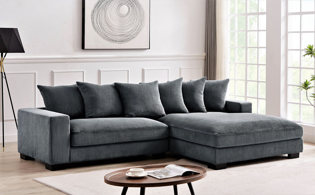 Dark gray L-shaped sectional sofa with chaise and lumbar accent pillows