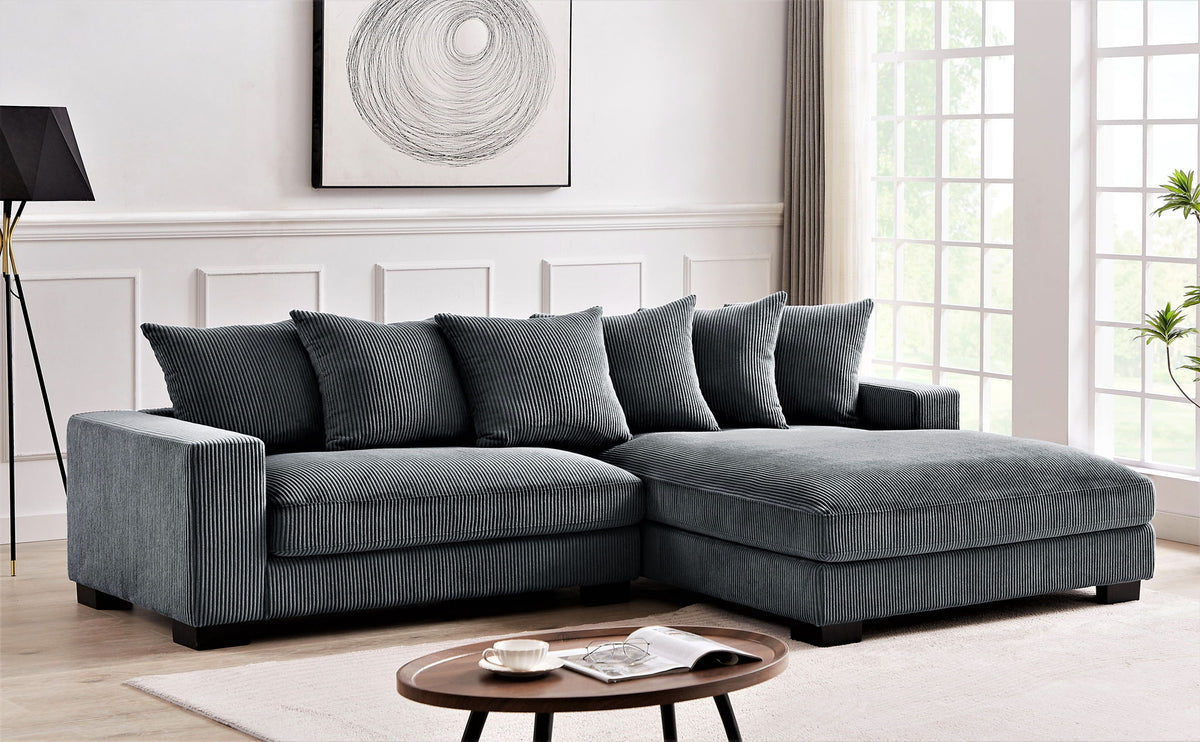 Dark gray L-shaped sectional sofa with chaise and lumbar accent pillows