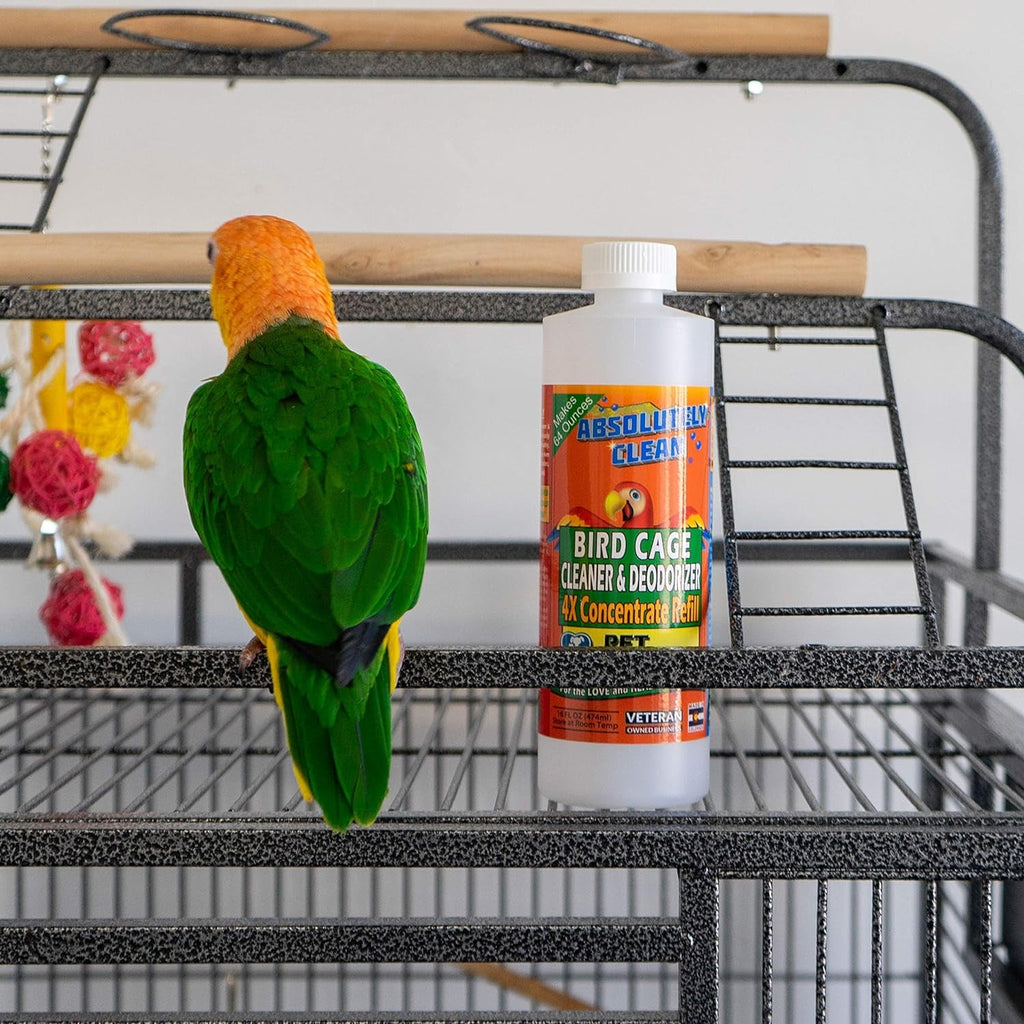 Bird cage cleaner and deodorizer bottle beside a green parrot on a cage