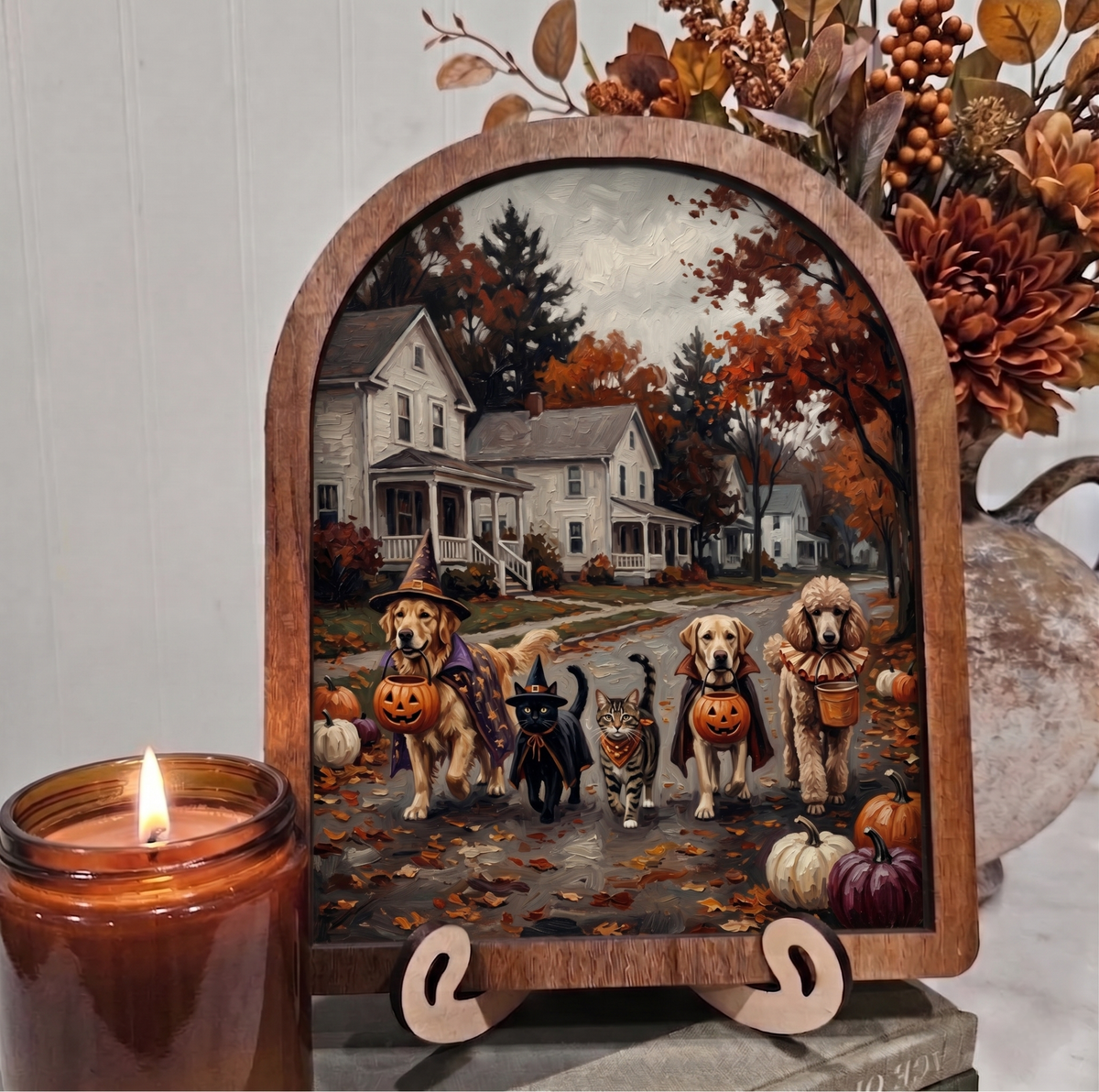 Halloween arch framed artwork with dogs and cats on easel stand, pumpkins and fall trees