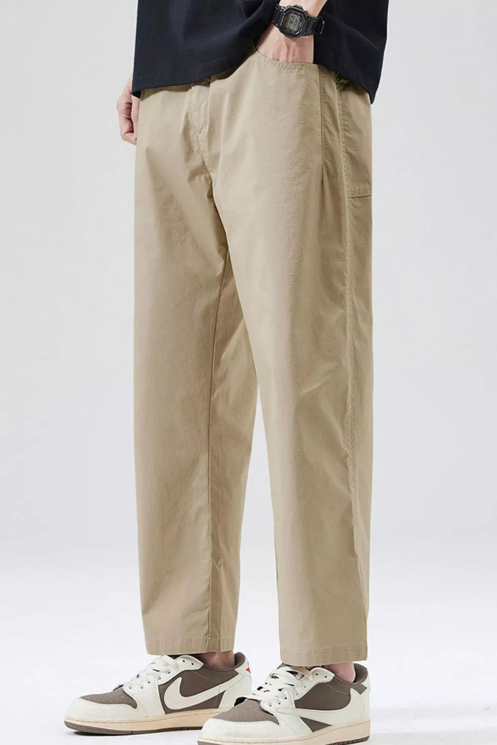 Men's khaki cropped loose-fit pants with belt loops and side pockets