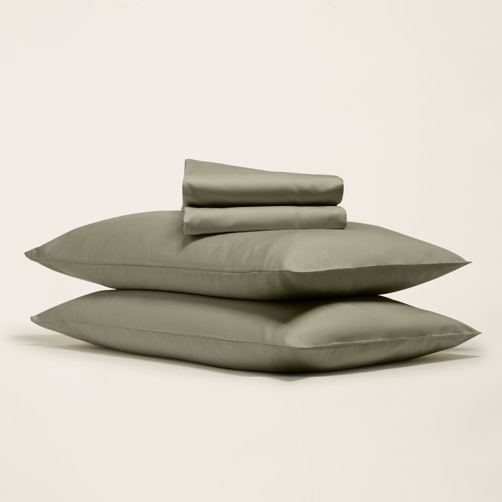 Moss green sateen sheet set with folded pillowcases and flat sheet