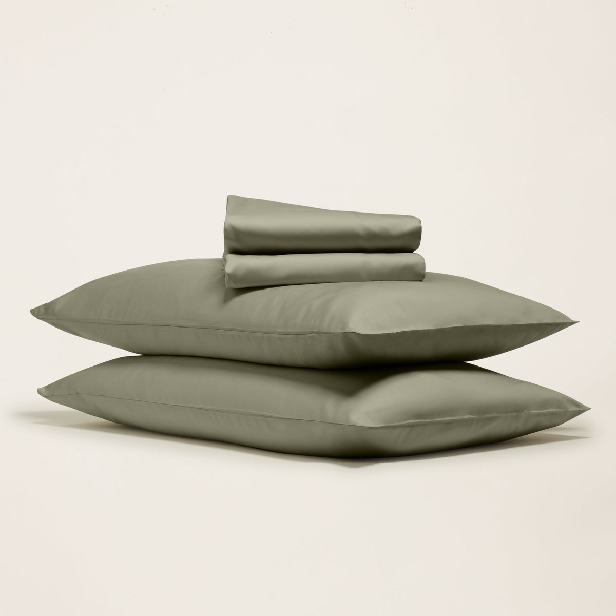 Moss green sateen sheet set with folded pillowcases and flat sheet