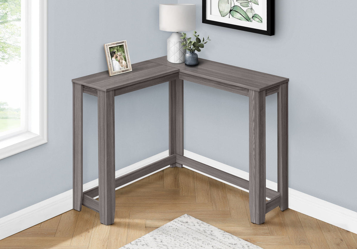 Corner accent console table in gray wood with square legs and open corner frame.