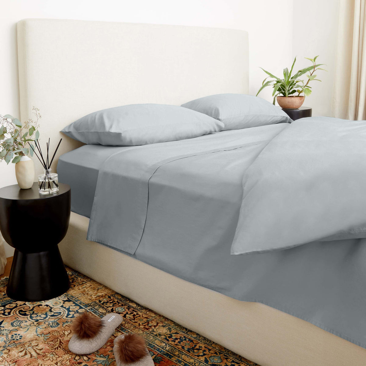 Slate blue sateen bedding set with duvet, pillows, and solid bed skirt