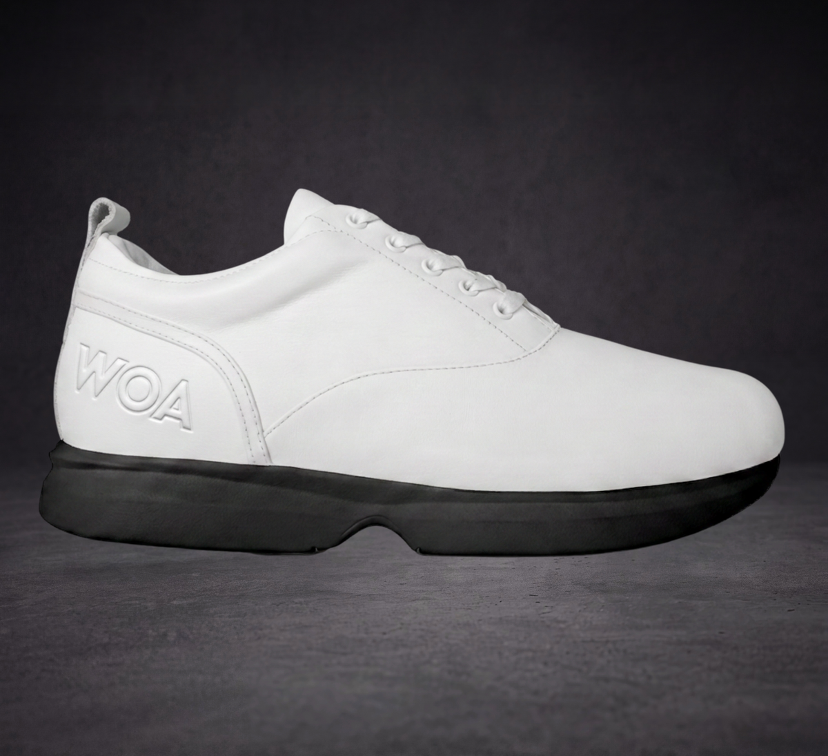 White WOA lace-up sneaker with black cushioned sole and side logo