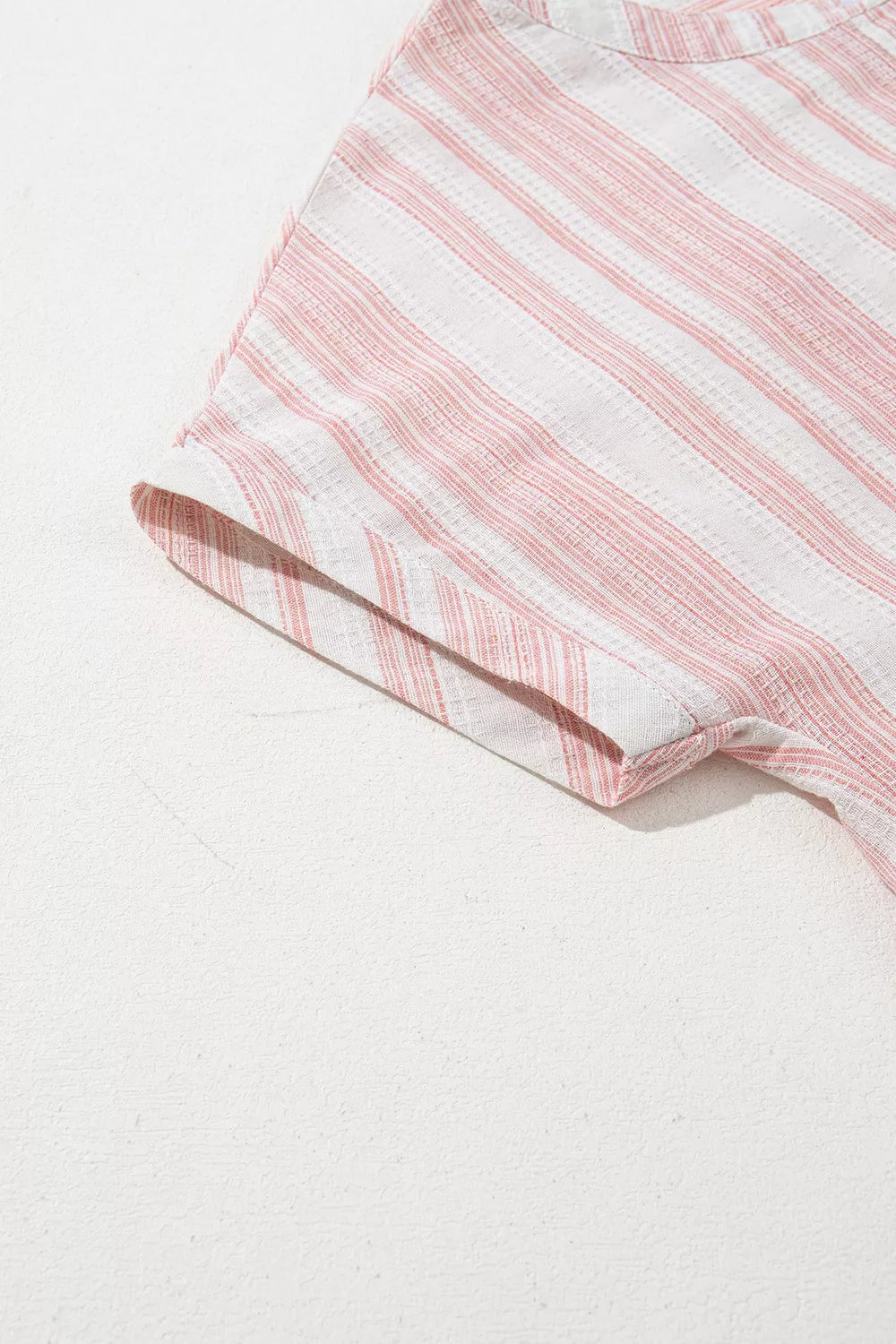 Dusty pink striped short-sleeve blouse with rounded neckline and sleeve hem