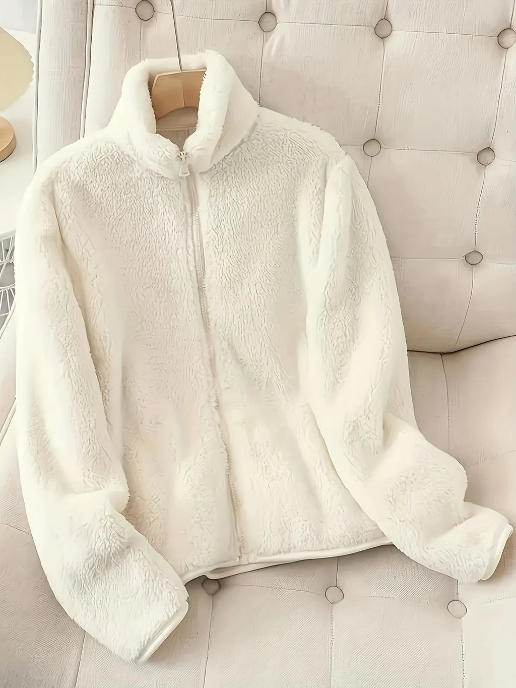 White fleece zip-up jacket with full front zipper and hood