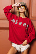 Red drop-shoulder top with glitter “MERRY” lettering and long sleeves