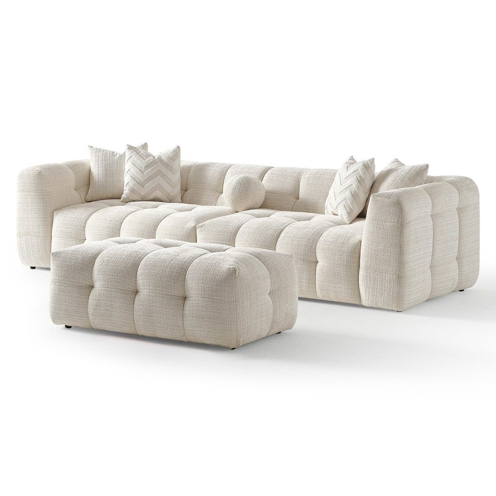 Cream tufted modular sectional sofa with two chaise sections and throw pillows