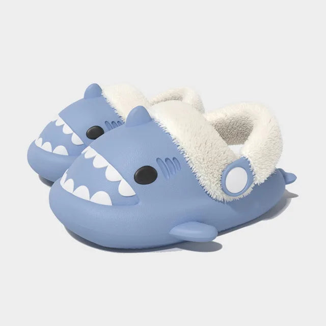 Light blue kids shark slippers with plush-lined cuff and white tooth graphic