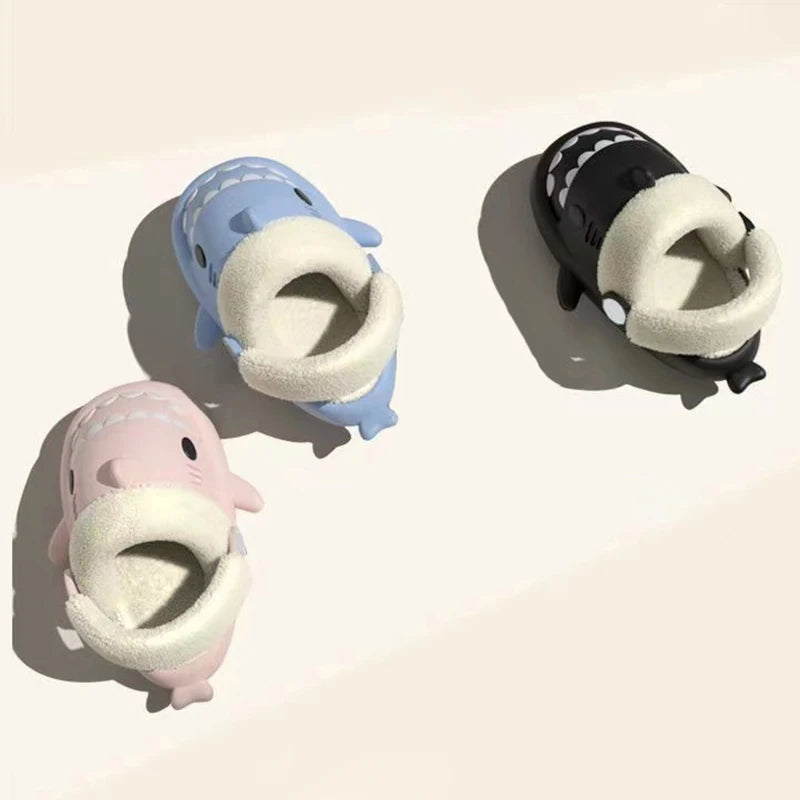 Kids shark slippers set in blue, black, and pink with plush lining and round eyes