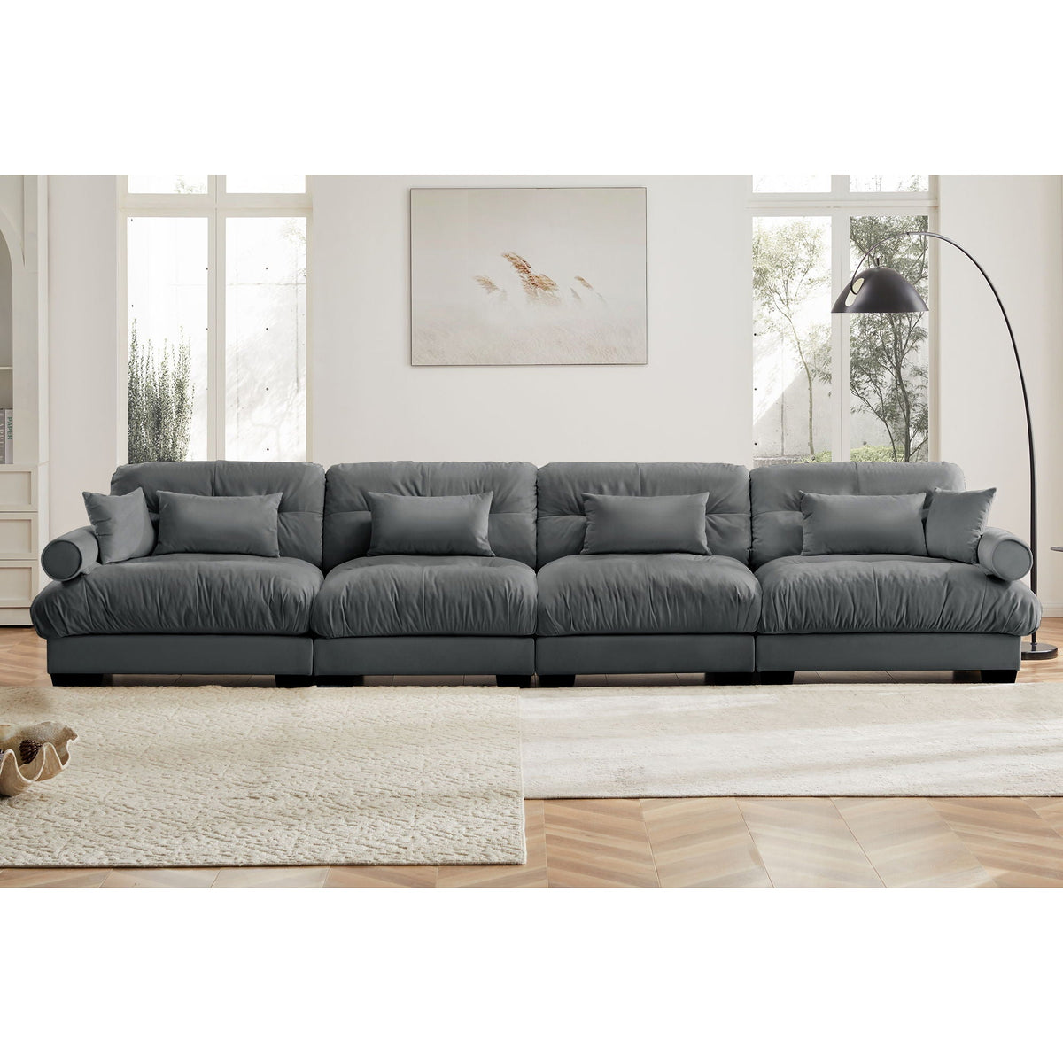 Dark gray modular sectional sofa with deep cushions, rolled arms, and block base